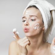 woman applying cream on her face